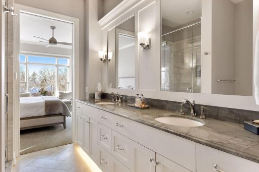 Double vanity, granite tops, ample storage, large shower, and walk-in closet are features of the primary bath