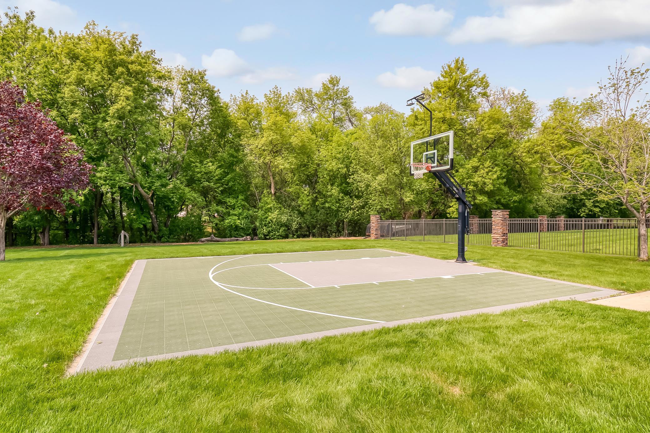 Backyard Basketball court
Basketball hoop has adjustable height control. Tempered glass backboard and LED hoop lights to enjoy an evening BB game!