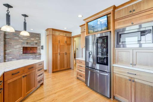 Remodeled kitchen with cherry cabinetry, SS Appliances, and quartz countertops