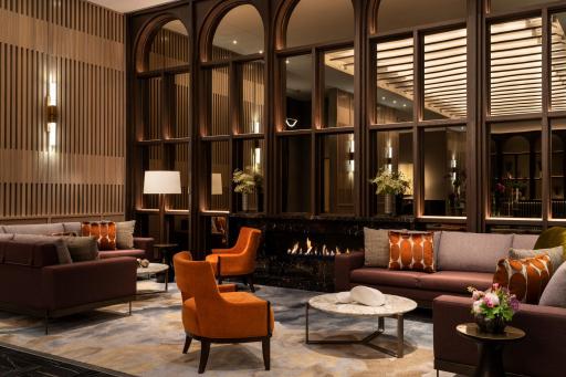 Five star hotel lobby includes cozy lounge areas with fireplace.