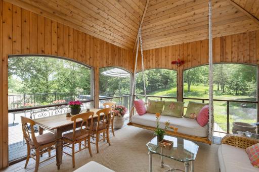 Charming Screened Porch leads to the Deck and views over pool