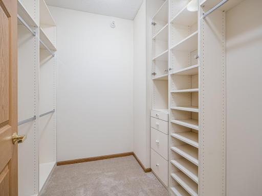 Large walk-in closet with California Closet System.