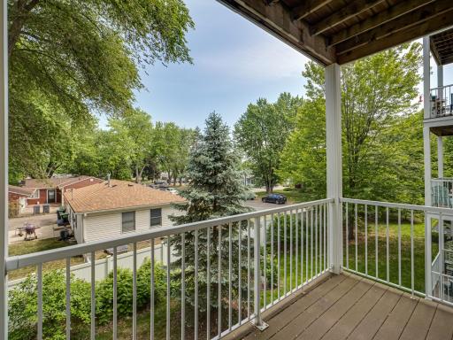 Deck overlooks quiet residential area with beautiful trees.