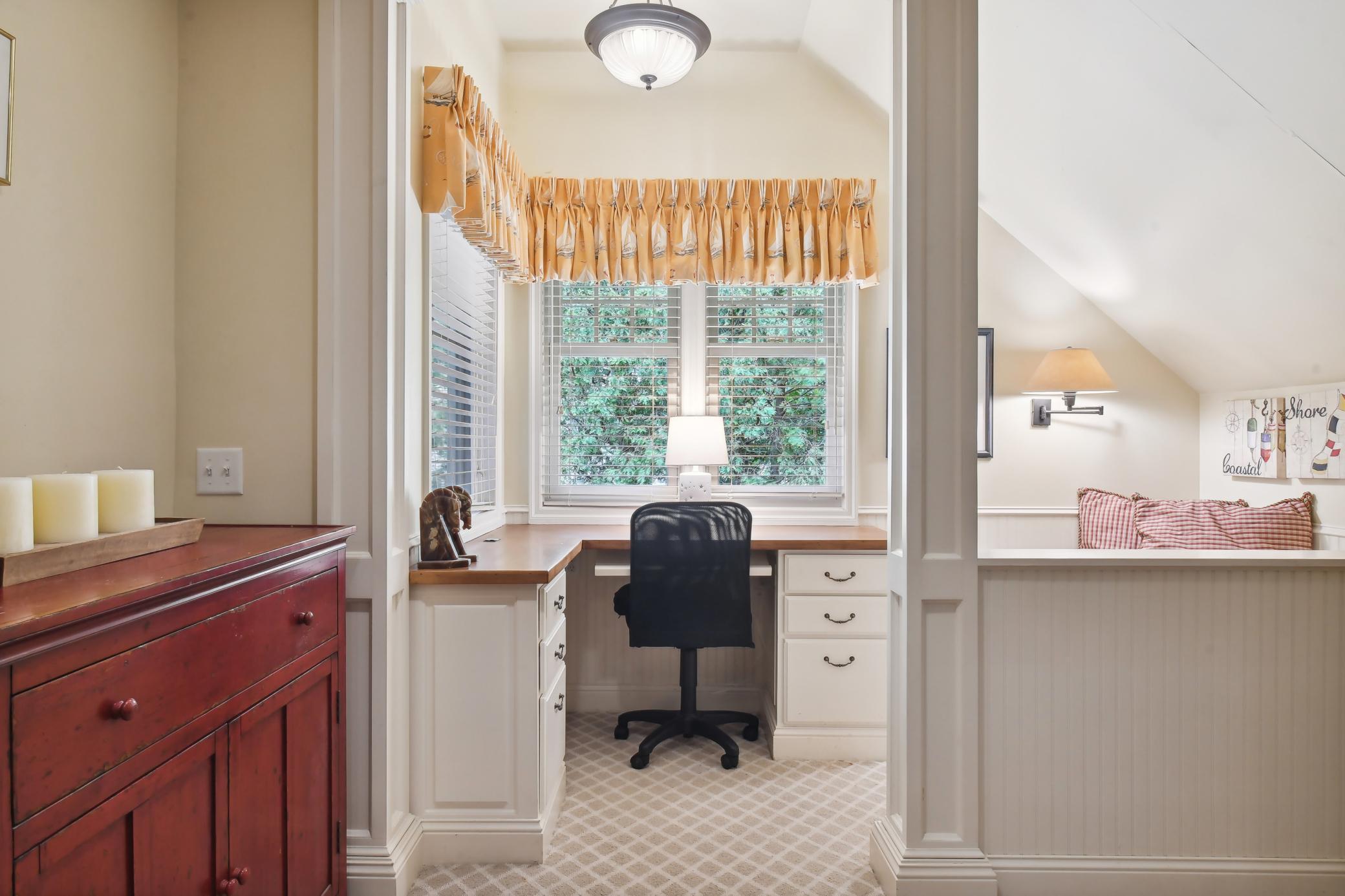 This cozy nook features built-in workspace, lake views and a built-in bench seat with storage.