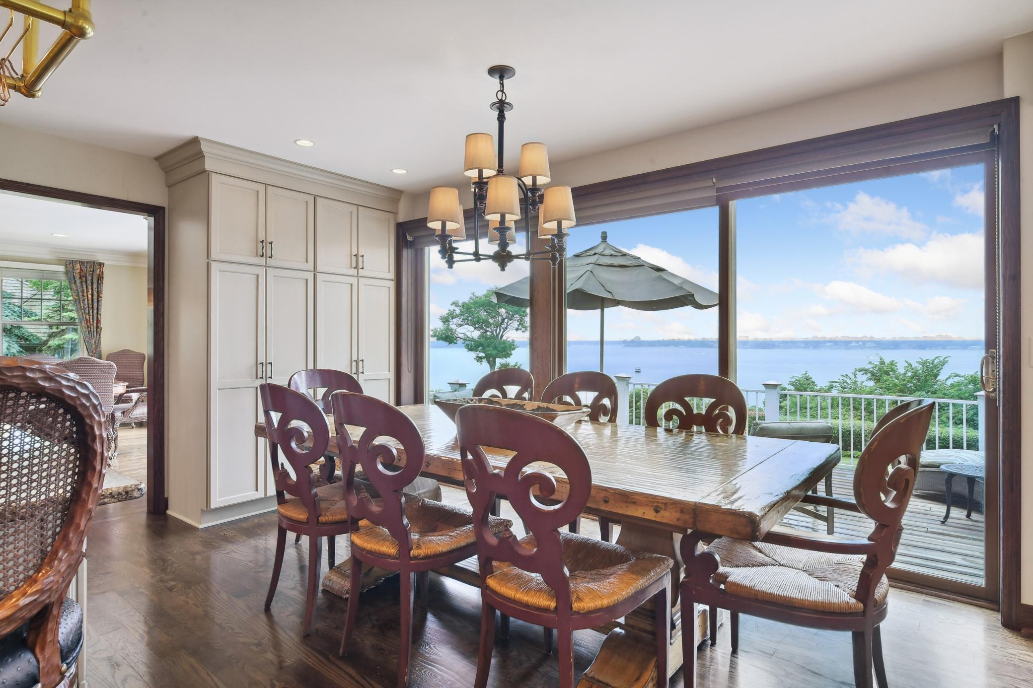 A wall of glass perfectly frames the long lake views in the informal dining area.