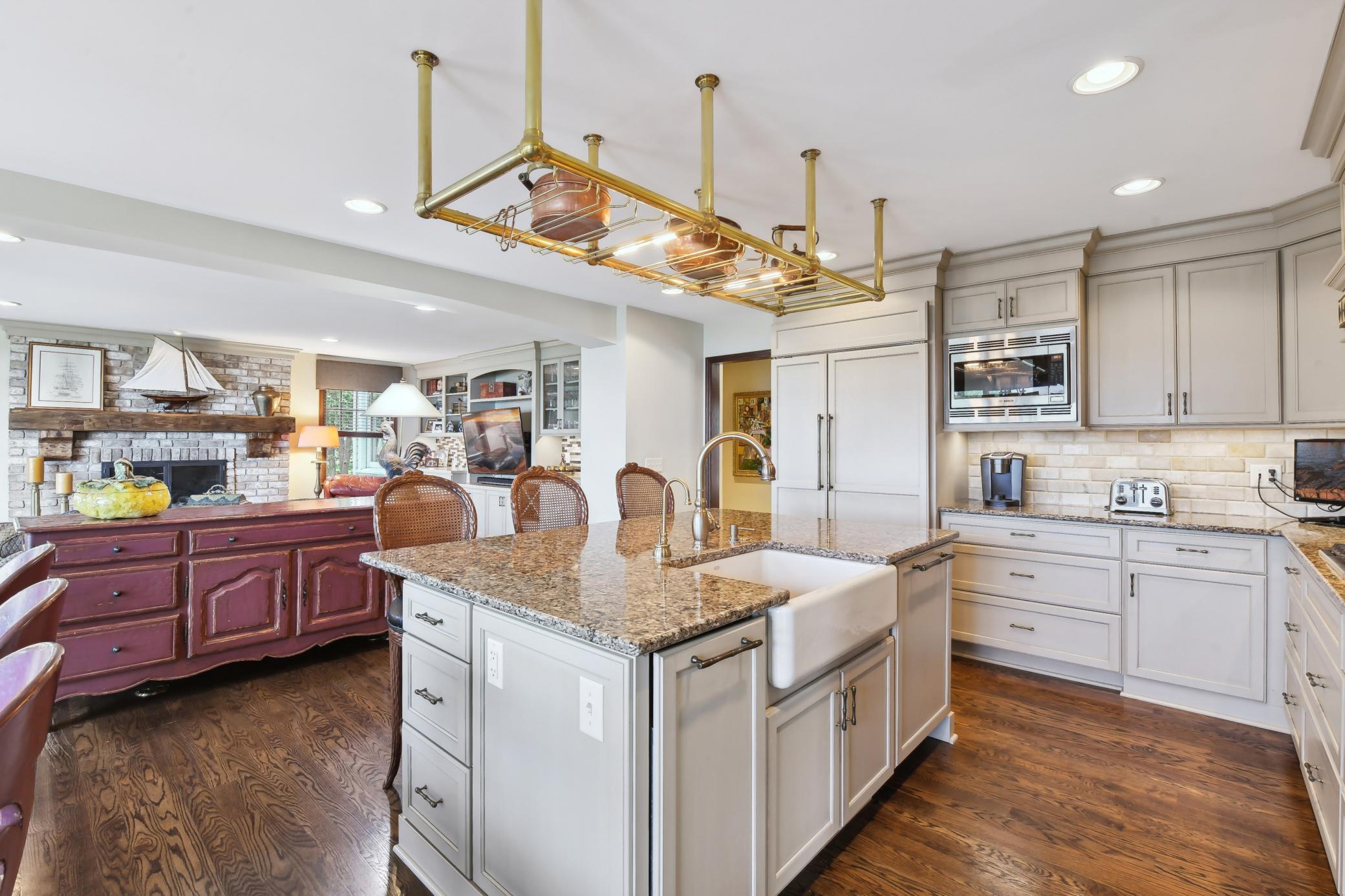 The center island features a farm sink and snack bar.