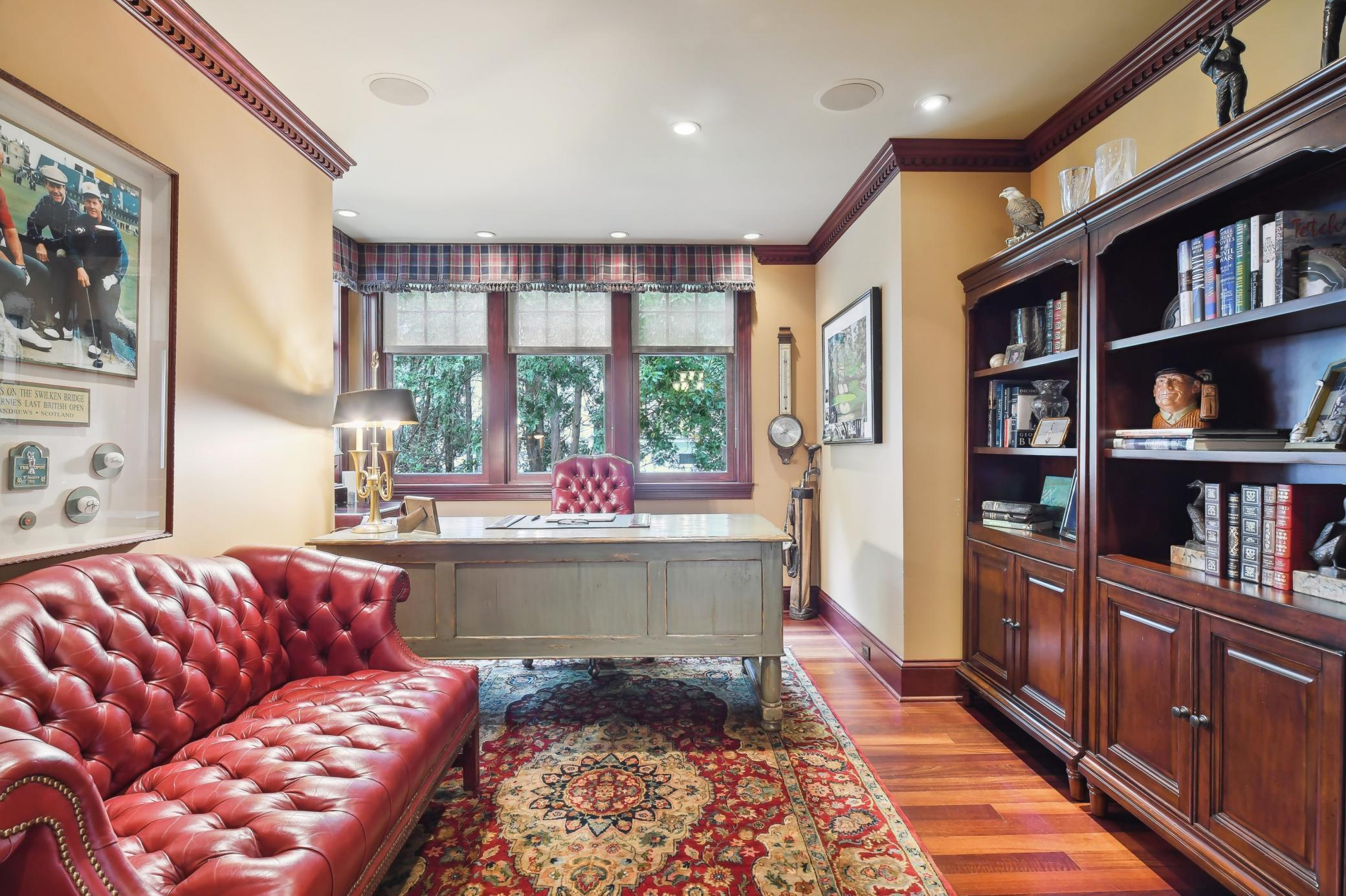 To the right of the foyer, the office/den features hardwood flooring, dental crown molding, lake views and built-in ceiling speakers.