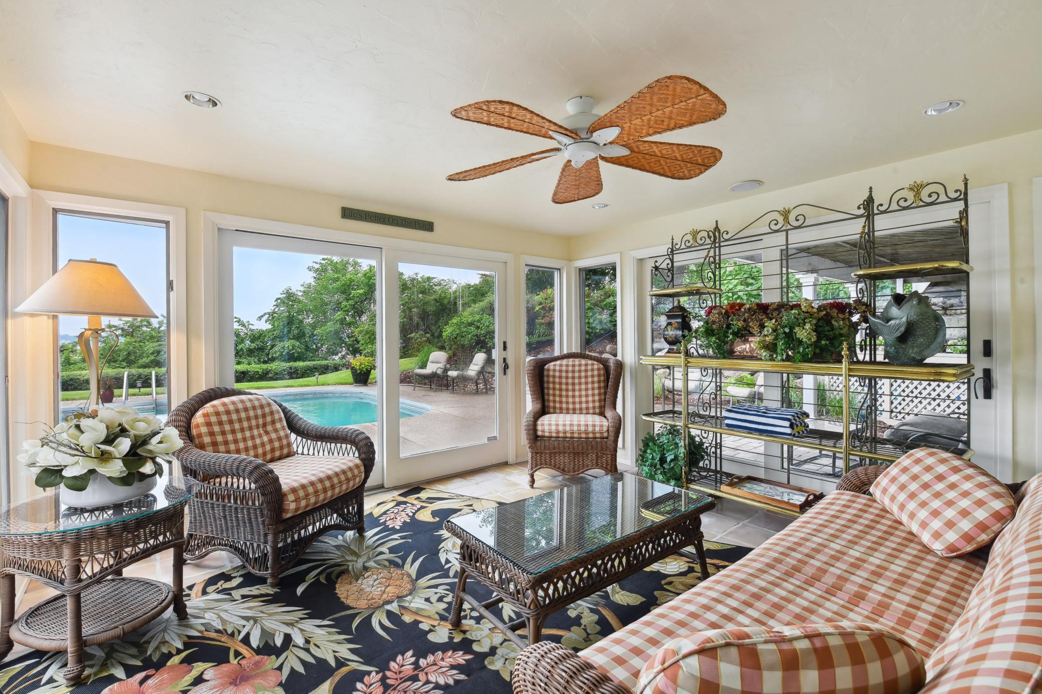 Sure to be a favorite escape, the porch offers access to the poolside patios and stunning lake views.