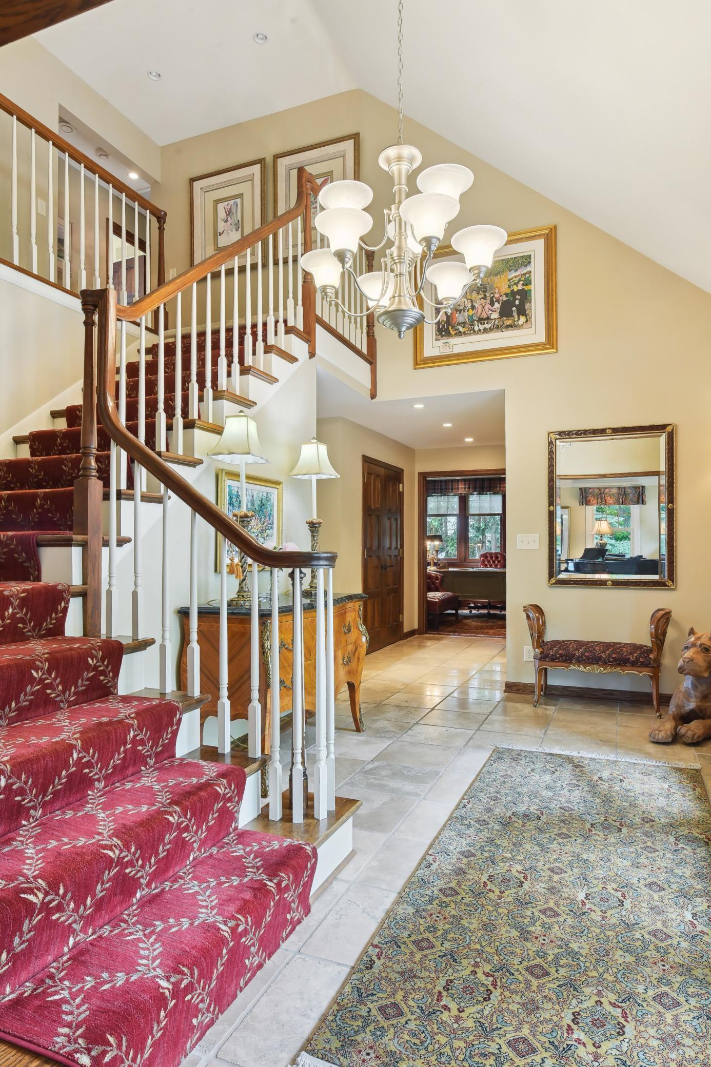 Glass front doors open to a spacious, vaulted foyer.