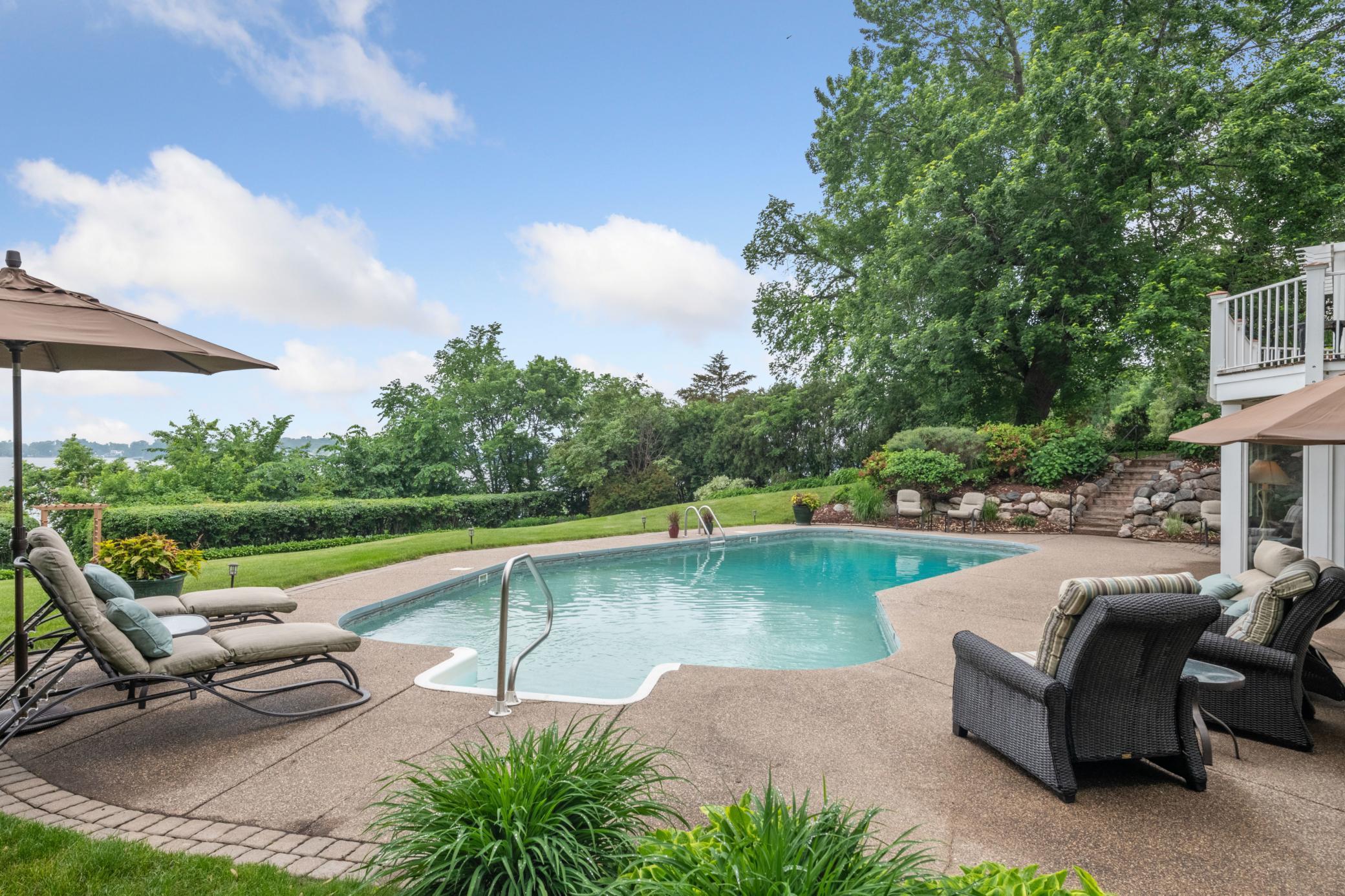 Wrapped in privacy and beautiful landscaping, the pool offers multiple seating areas.