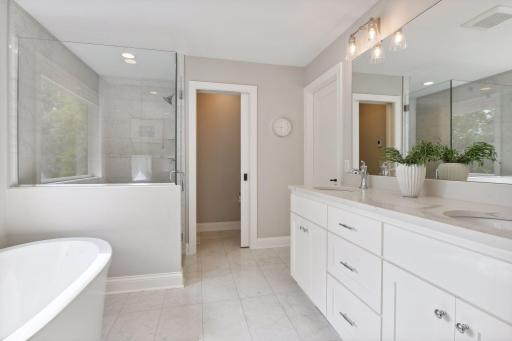 Primary bathroom with soaking tub and separate shower.