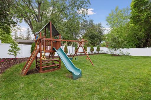Yard is fully fenced with lovely landscaping.