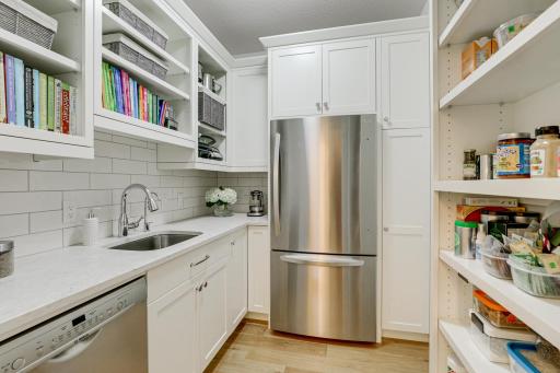 Photo of previously built home. View of the large work-in prep pantry offering a dishwasher, sink, refrigerator and many cabinets for all your storage needs.