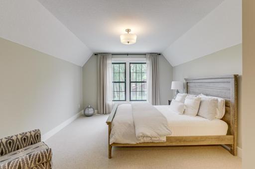 Photo of previously built home. This bedroom provides a lit walk-in closet, sun-filled windows with front yard view and is connected to a full Jack & Jill bathroom.