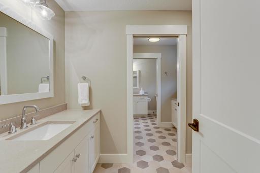 Photo of previously built home. This well-designed Jack and Jill bathroom connects 2 of the upper level bedrooms and provides plenty of storage and countertop space at the oversized vanity on each end.