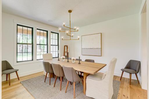 Photo of previously built home. Elegant dining room perfectly suited to meet the demands of large family gatherings or more intimate dinner engagements.