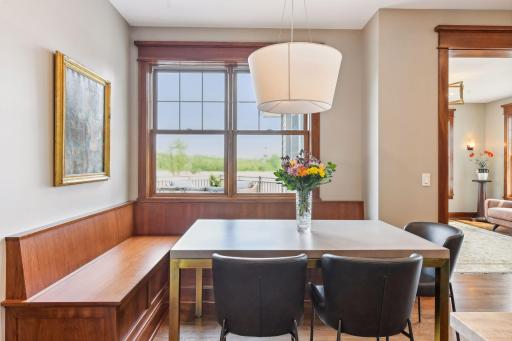 Breakfast nook has built-in seating with storage underneath.