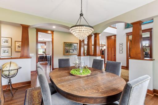 Formal dining has wood columns and custom lighting.