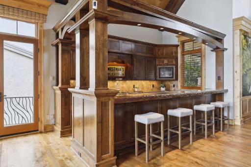 Custom bar with hand carved table is a statement piece