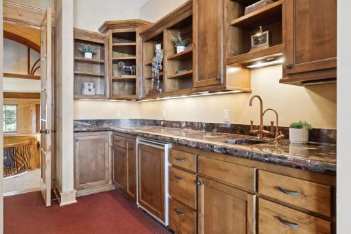Mini kitchen in the home office with a sink and refrigerator