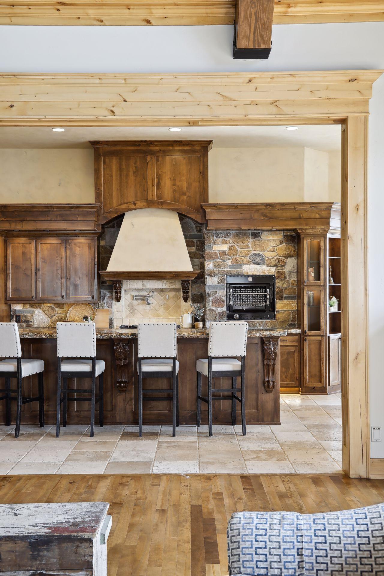 Custom designed cabinetry and hand crafted detail with stone tile flooring.