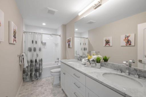 Full bath on upper level featuring dual vanity with granite counter.
