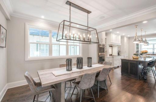 Informal dinning area nicely appointed with a wall of windows, crown molding and 5" mop boards.