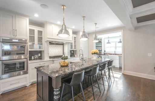 The luxurious gourmet kitchen features granite counters, Thermador appliances including double oven, large center island and butlers pantry.