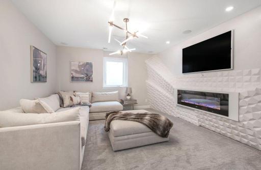 Second living area located in the lower level features gas fireplace.
