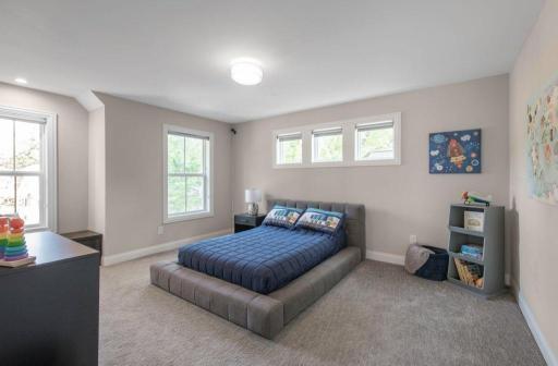 One of two additional upper level bedrooms. Window bench Walk-in closet with built-in organizer.