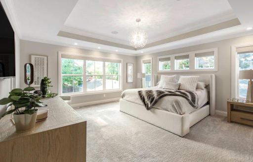 Large primary suite on the upper level with abundant windows and box vaulted ceiling.