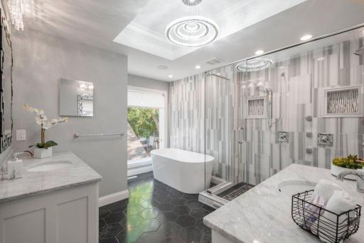 One of the most luxurious primary bathrooms you will ever see. Heater floors, glass shower with dual heads, soaking tub, separate vanities and second walk-in closet.