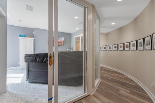 Curved hallway from the family room brings you to the spa room.