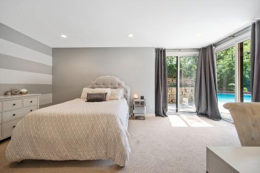 Another lower level bedroom, also an en suite, walks out to the patio with the pool.