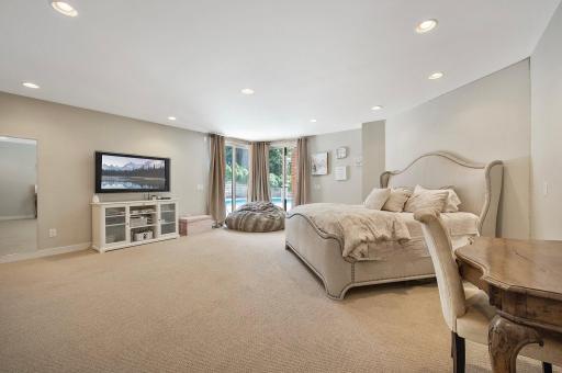 Lower level bedroom that has glass door to the pool area.