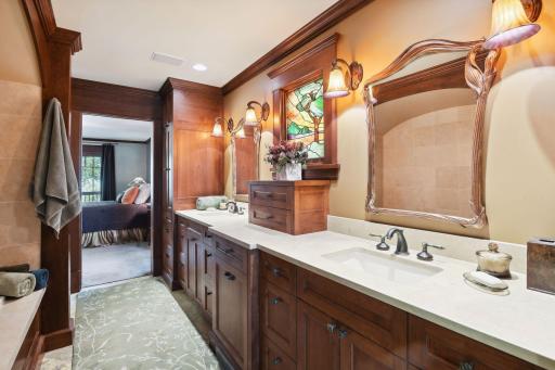 The walk-thru bathroom between both bedrooms includes dual sinks, opulent lighting and Jerusalem stone tile.