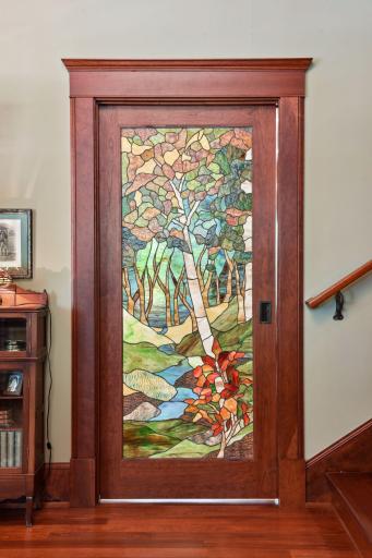 One-of-a-kind stained glass pocket door between front foyer and the kitchen.