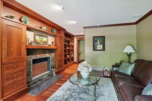 The richly detailed library with wood burning fireplace can double as a Media/TV room or home office.