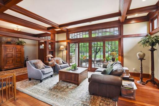 Living room with box beam ceiling and sliding door to front veranda.
