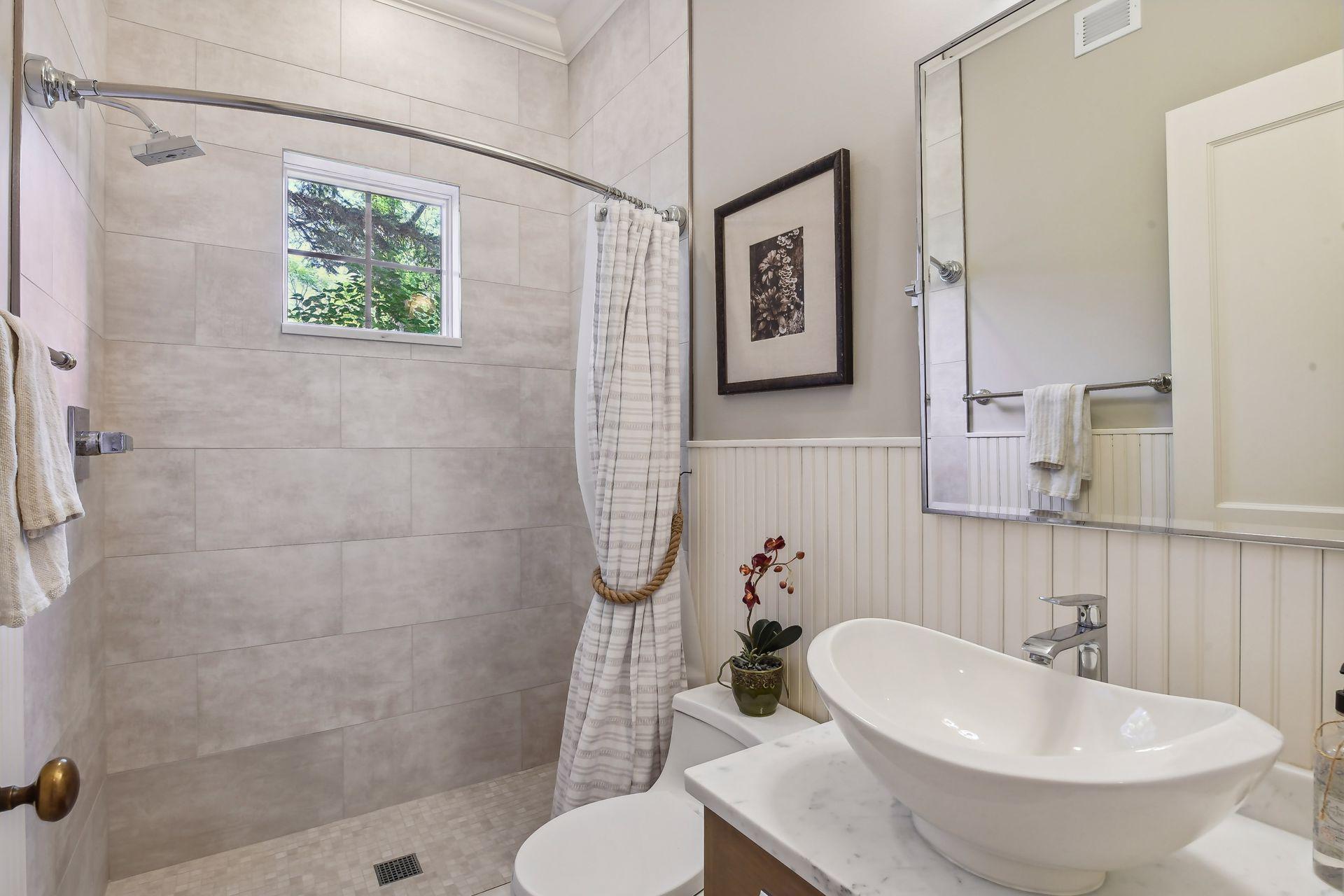 Next to the Mud Room is a convenient 3/4 Bathroom that was completely updated with an all new tiled shower and designer vanity. This is a fantastic space for rinsing off after a day on the lake!