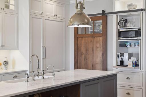 The Kitchen is equipped with Miele and Viking appliances. Tucked away behind the custom barn door is the Kitchen Pantry and the convenient appliance cabinet is perfect for your coffee machine and microwave.