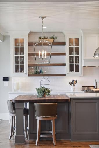The custom sitting area features hidden cabinetry for additional storage.