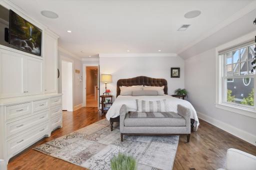 A luxurious retreat, the Primary Suite has been remodeled with a built-in wardrobe featuring pull-out shelving. You will also find a walk-in closet with custom organizers adjacent to the Primary Bathroom.