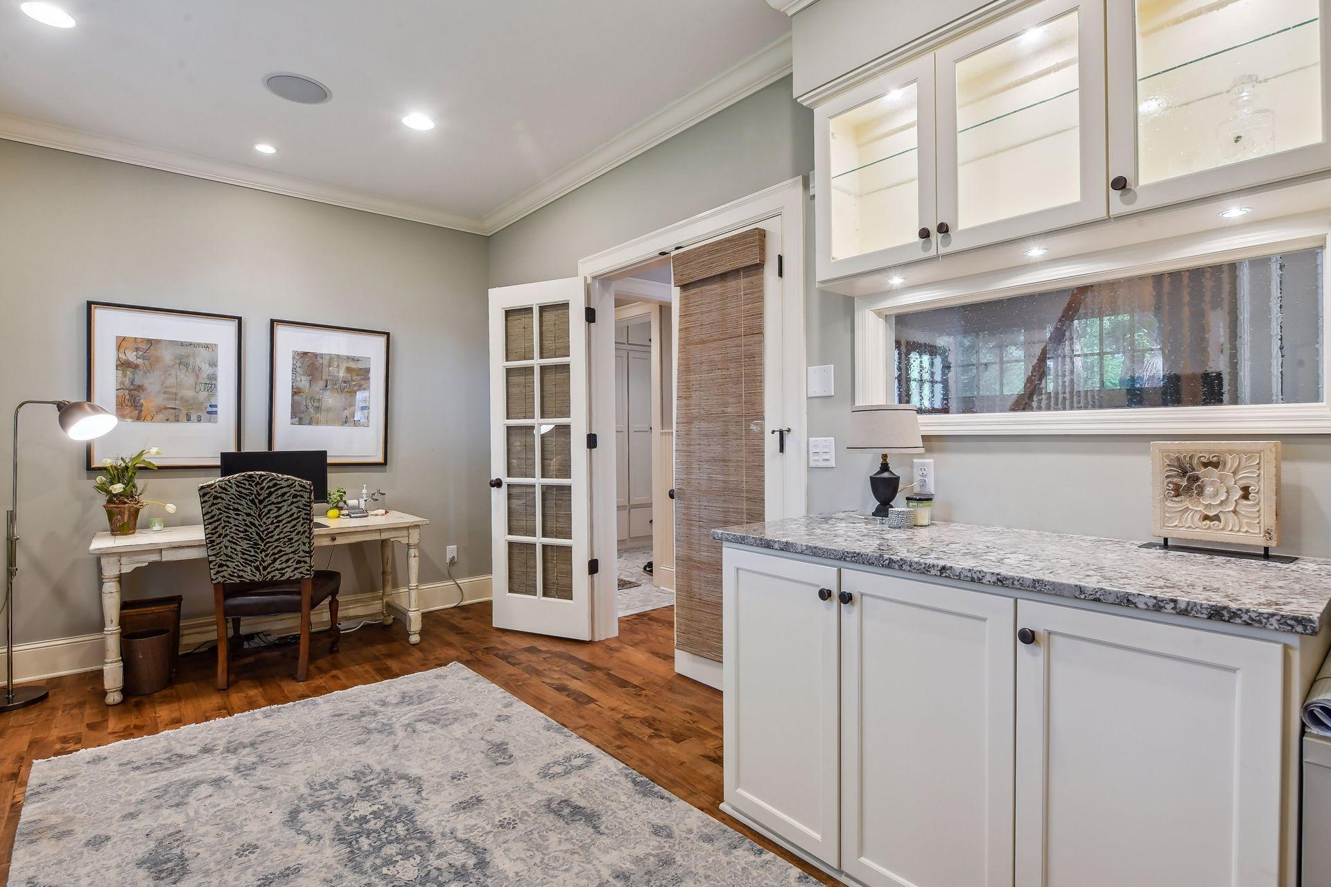Working from home is a breeze in the main level Home Office. The space was remodeled to include the custom built-in workspace and glass-front cabinetry.