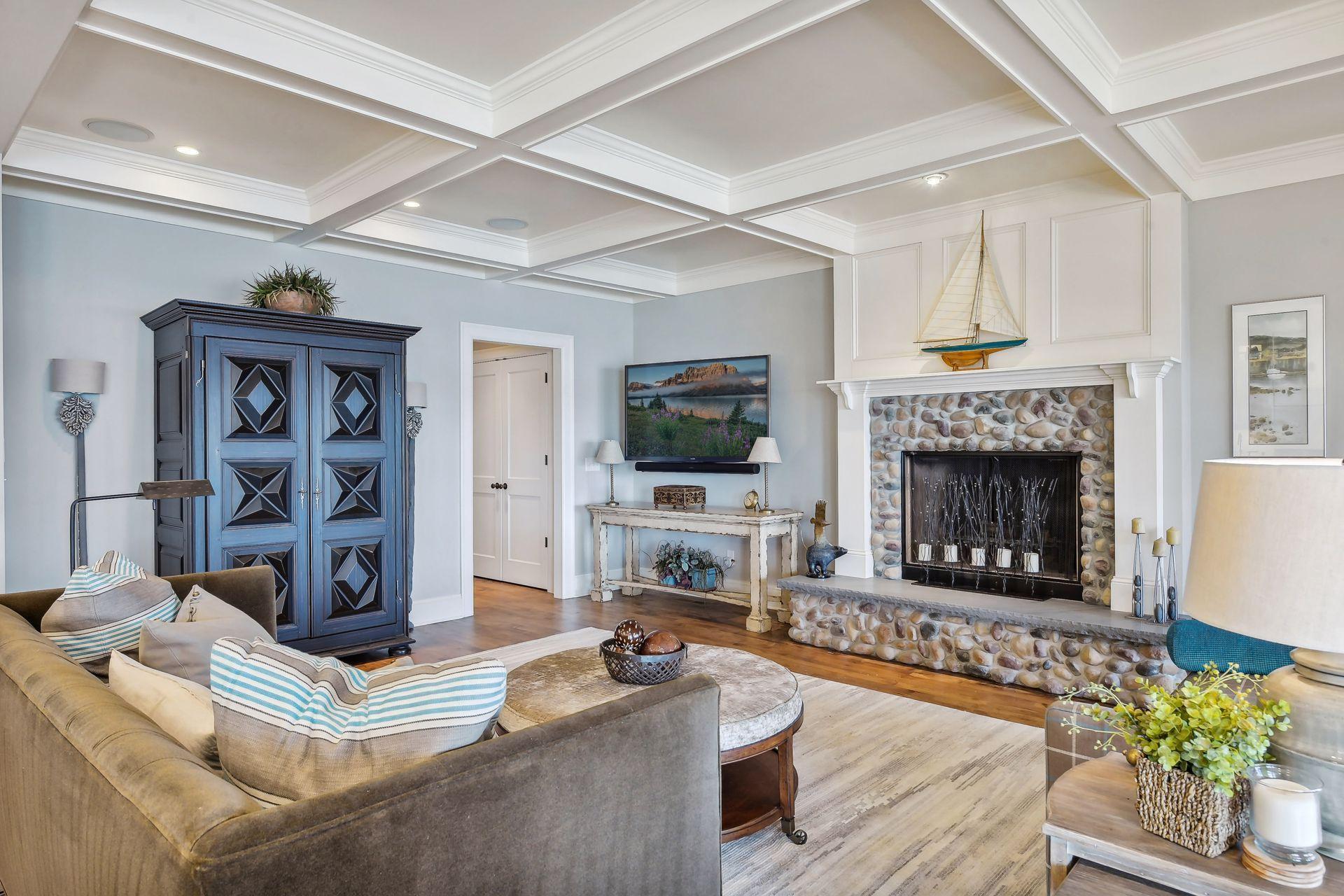 The spacious Family Room features a coffered ceiling and inviting fireplace.