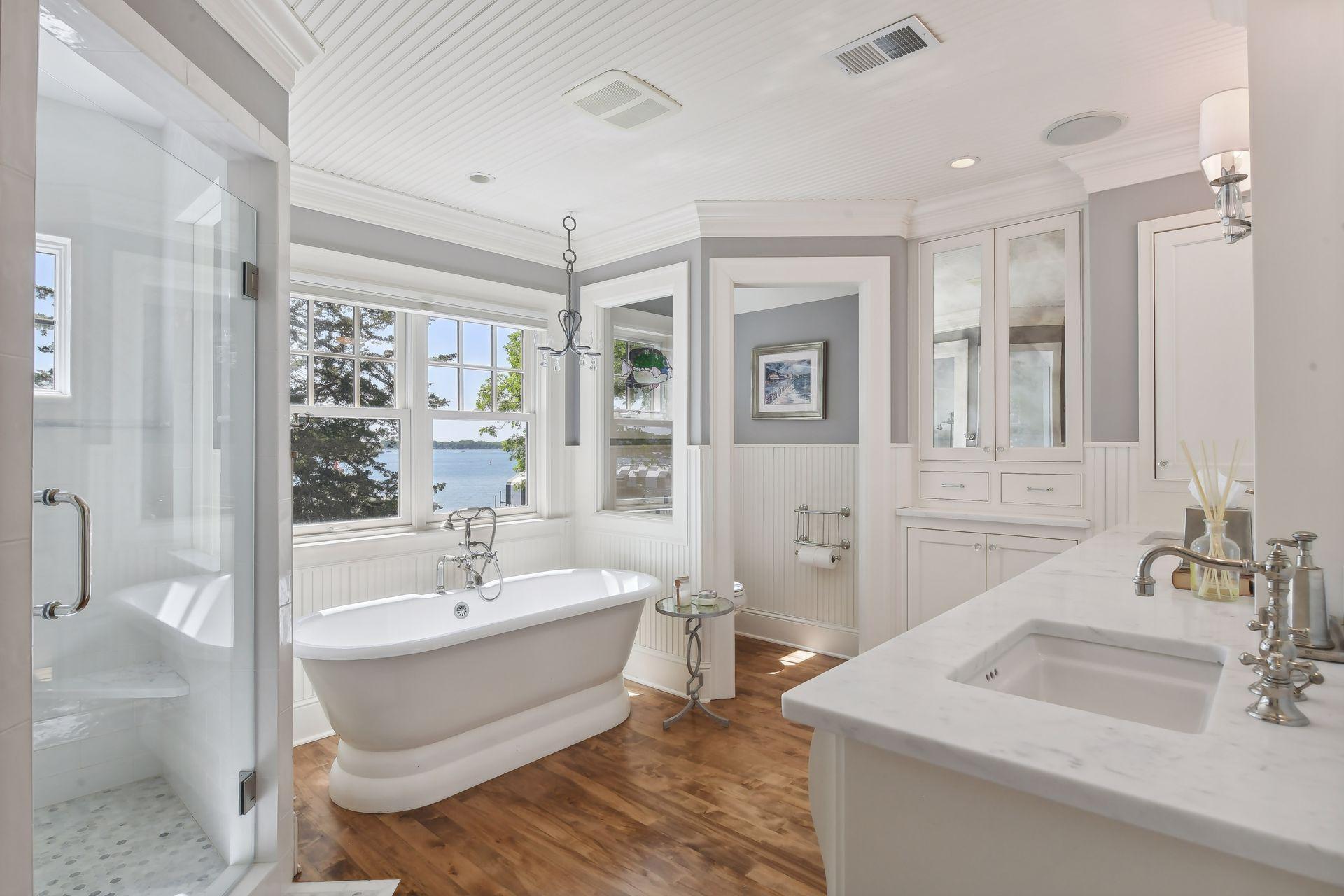 The Primary Bathroom features extensive millwork and a newly tiled shower and a beautiful soaking bathtub.