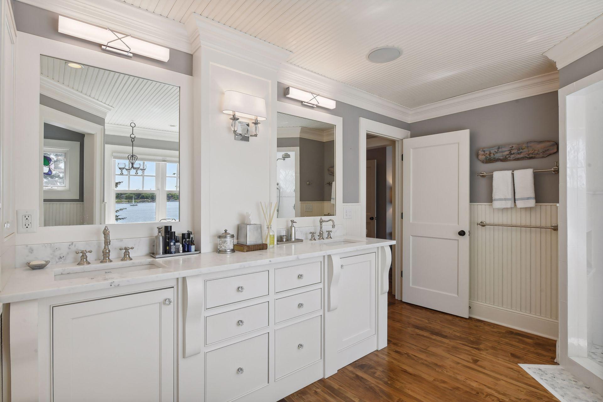 The double vanity features an updated countertop and sinks with new fixtures.