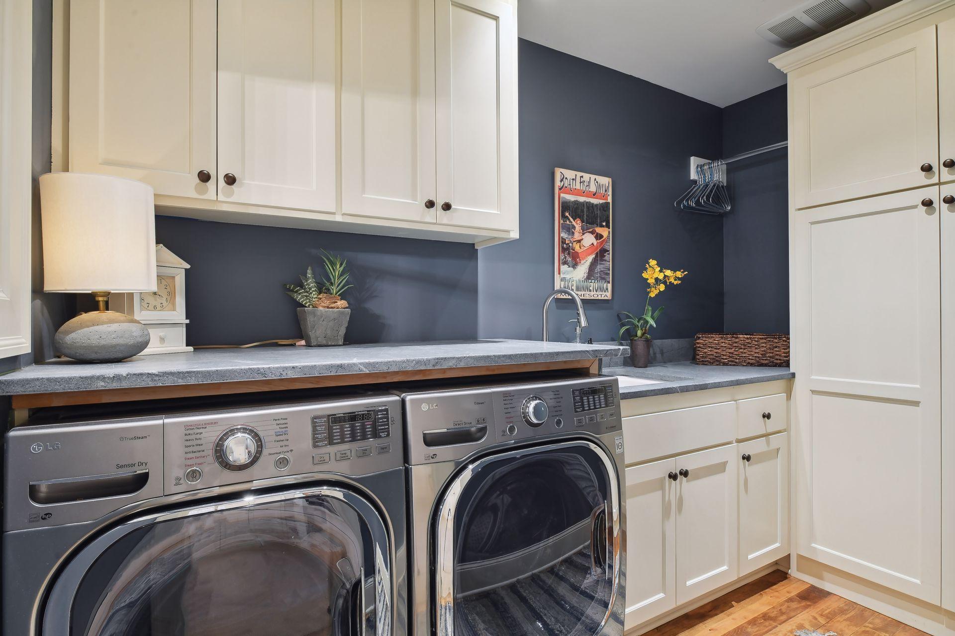 Well-appointed, the laundry features built-in cabinets, a laundry sink and folding counter.