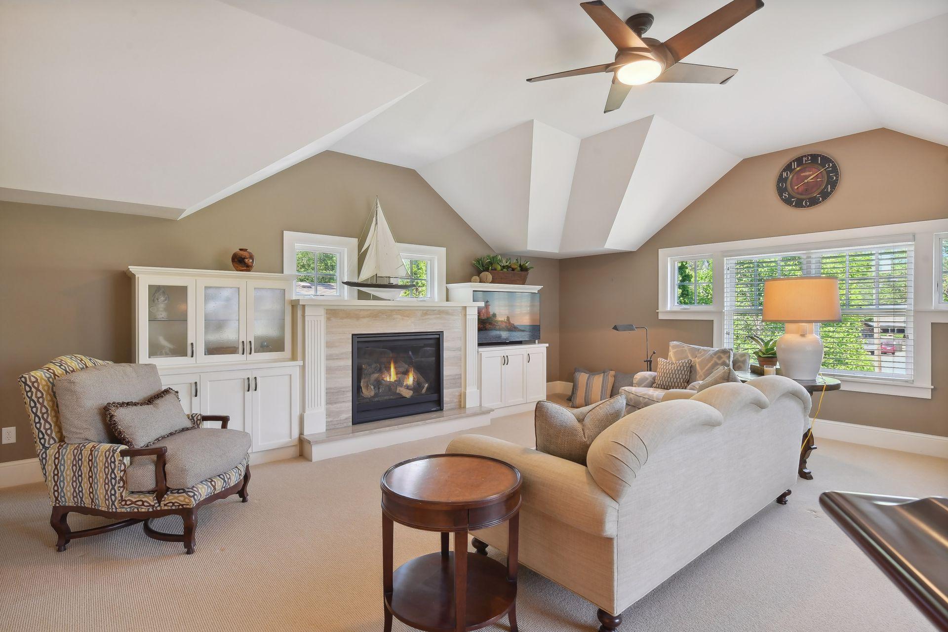 The Bonus Room over the garage could be used as the fourth bedroom and features a built-in gas fireplace flanked by custom cabinetry.