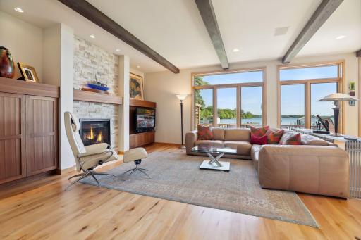 Inviting great room features a gas fireplace, wood beam ceiling accents